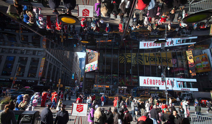 People are reflected in a mirror as they shop during Black Friday sales in New York November 29, 2013. Black Friday, the day following Thanksgiving Day holiday, has traditionally been the busiest shopping day in the United States. Black Friday shopping stampede in US