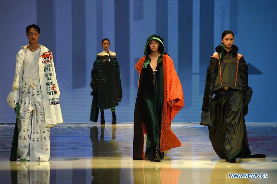 Models present fashion designs of graduates in Beijing