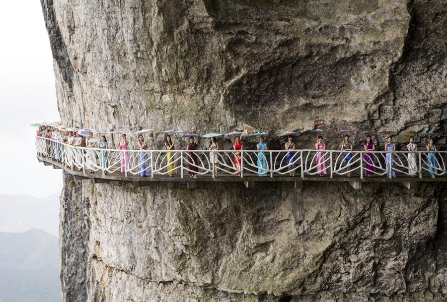 Qipao show presented on plank road built along vertical cliff in SW China