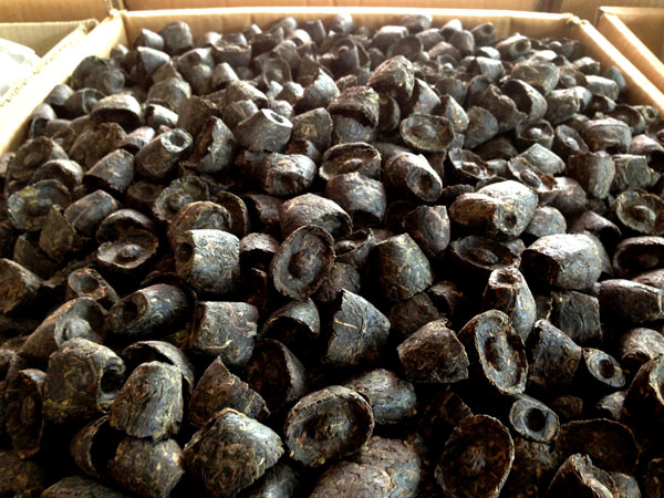 Loose tea leaves are pressed into ingot-shaped bricks. The new tea party