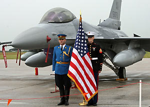 Serbian (L) and U.S. army soldiers stand in front of one of two U.S. F-16 military airplanes at the Batajnica military airport near Belgrade June 23, 2006.