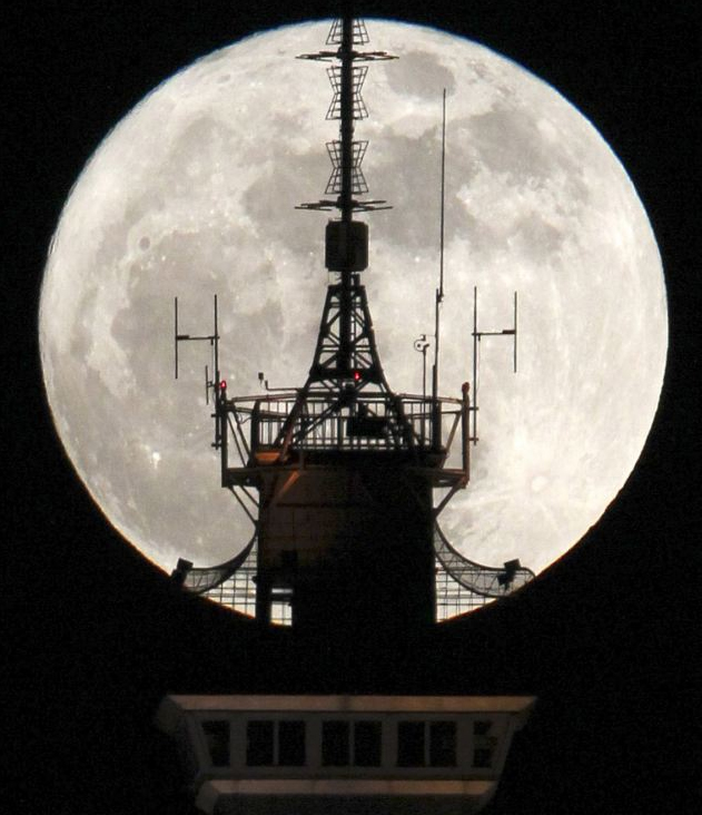 飛機(jī)將圓月一分為二 全球“超級(jí)月亮”美圖（圖）