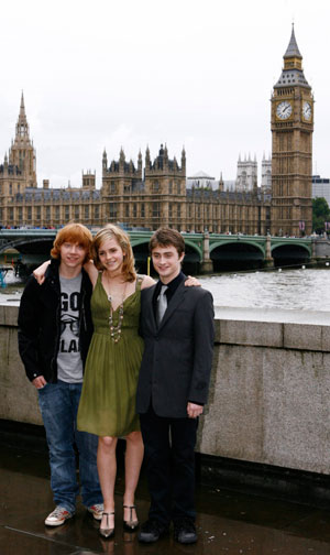 Actors Daniel Radcliffe (R), Rupert Grint (L), and Emma Watson pose during a photocall to promote the new film