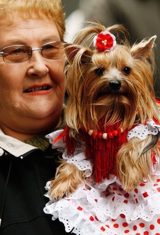 A pet owner waits in line to have her dog blessed at Madrid's San Anton church January 17, 2007. Hundreds of pet owners bring their animals to be blessed every year on the day of San Anton, Spain's patron saint of animals.