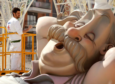 A craftsman adds finishing touches on a float ahead of the