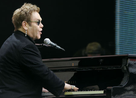 Elton John performs at the start of the Concert for Diana at Wembley Stadium in London July 1, 2007. Princess Diana's sons staged a charity concert in her memory on Sunday which they hope will quell her critics and celebrate her humanitarian achievements.
