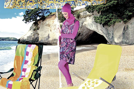 A model presents a head-to-heel, long-sleeved baggy swimsuit known as Hasemas.