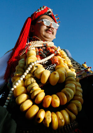 A man wears traditional costume during the Tibetan Kangba Art Festival in Yushu county, northwest China's Qinghai province July 25, 2007. The five-day art festival provides visitors with folk performances, costume displays and horse racings, local media reported. Picture taken July 25, 2007.