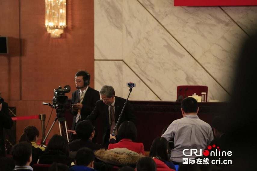 兩會新聞發布會 記者用“自拍神器”自拍