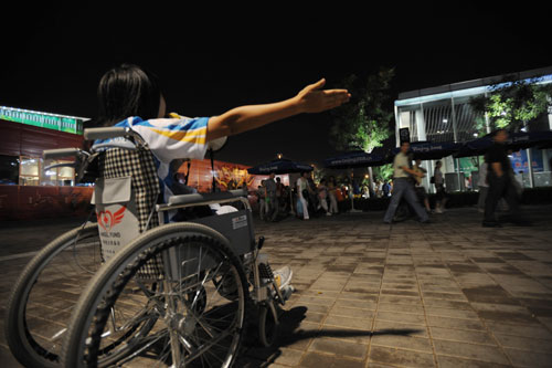 Wheelchair volunteer guides spectators