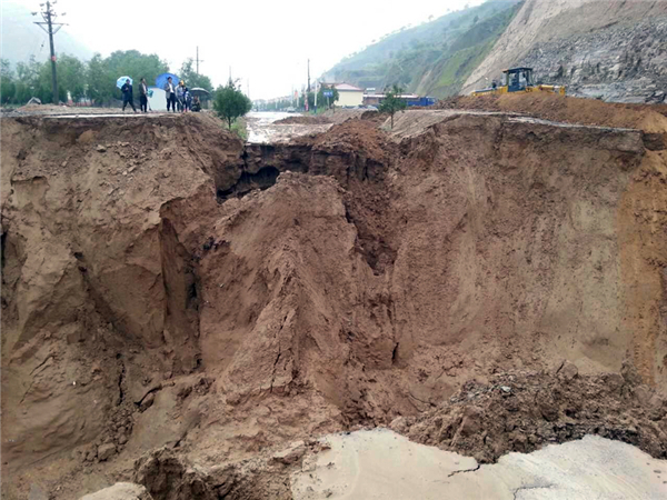 Rain-triggered floods destroy farmlands at Huanxian county, Northwest China’s Gansu province on July 15,2013 NW China floods leave 10 dead or missing