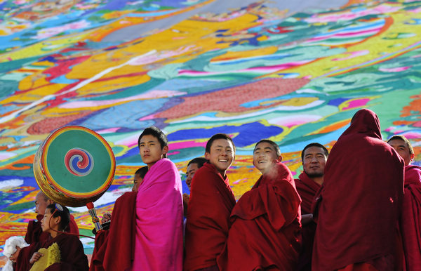 Monks pose for a photo on Friday in front of a thangka - a Tibetan scroll painting - during a Tibetan Buddhism festival at the Labrang Monastery in Gansu province. The monastery, which was founded in 1709, is a major venue for Buddhist ceremonies. Labrang Monastery: a magnet for pilgrims (Gannan)