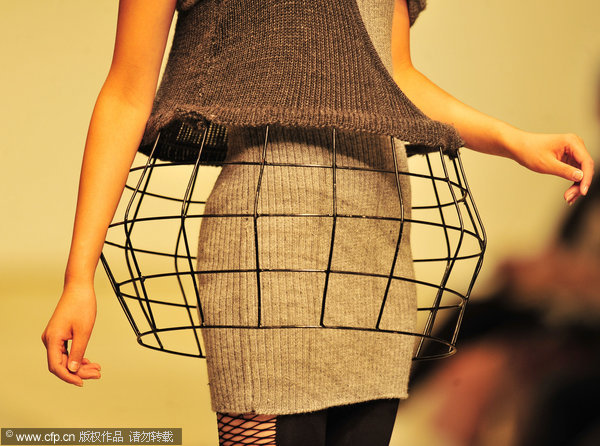 A model wears creations by graduates of Wuhan Textile University in Wuhan, Central China's Hubei province, May 18, 2011. Fashion graduates show what they’ve got