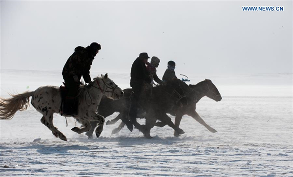 Men ride on horseback during Naadam game in North China