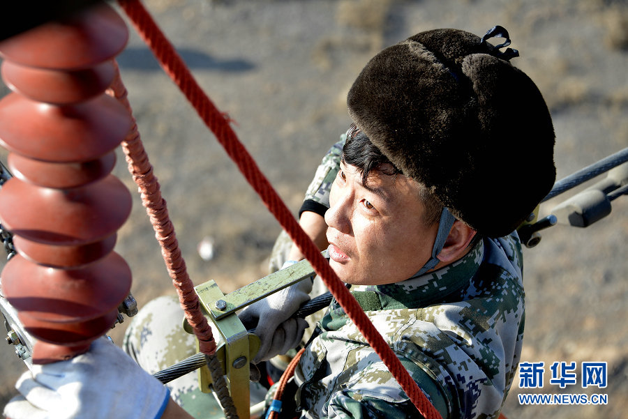 Electricians work on power lines in Wuhai