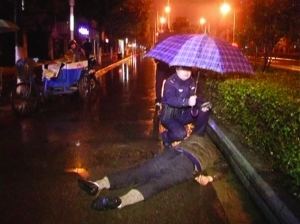 Police holds umbrella for a drunken man