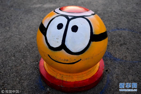 Cartoon road barriers decorate street in Shenyang