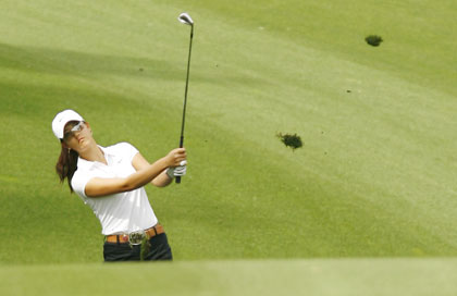 Michelle Wie of the U.S. follows through on her second shot on the fourth hole at the LPGA Kraft Nabisco Championship golf tournament in Rancho Mirage, California March 30, 2006.