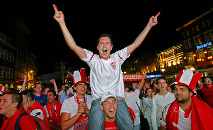 Sevilla's soccer fans celebrate their team's victory over Middlesbrough, in Market square in the centre of Eindhoven, the Netherlands, a few minutes after the UEFA Cup final between England's Middlesbrough and Spain's Sevilla at the PSV Stadium May 10, 2006.