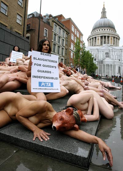 Nude PETA (People for the Ethical Treatment of Animals) activists protest against the Queen's palace guards' bearskin hats at Peter's Hill in central London May 21, 2006. The banner reads "Bears slaughtered for the Queen's guards".