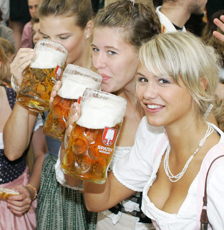 Young women in traditional Bavarian clothes toast with one-litre beer mugs during the opening day of the Oktoberfest in Munich in this September 17, 2005 file photo. The FIFA soccer World Cup 2006 final will be held in Germany from June 9 - July 9.