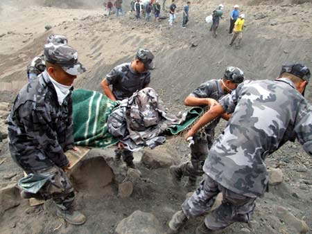A handicapped woman is carried by a rescue police squad to be evacuated from Cusua, a village near the Tunguharua volcano, some 178 km (108 miles) south of Quito July 15, 2006. Ecuador's Tungurahua volcano spewed ash, gases and molten rocks on Friday, forcing authorities to evacuate four nearby villages after the crater registered its most volatile activity since a 1999 eruption.