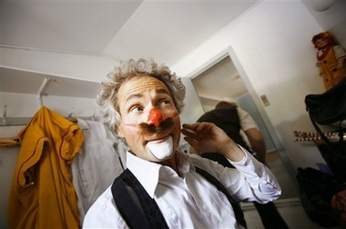 Danish clown Benny Schumann, 61, applies makeup while preparing for a show in Copenhagen, Denmark Wednesday Aug. 9, 2006. Clowns from Italy, Belgium, Denmark, Spain and Russia among other places are gathering for the 11th International Clown Festival in Denmark held Aug. 10-20 at the Bakken amusement park 20 kilometers (13 miles) north of Copenhagen.