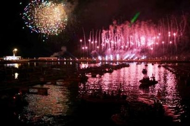 Boats float on a bay during a display of fireworks during the opening ceremony of the 2006 Qingdao International Regatta sailing competition in Qingdao, China's eastern province of Shandong, August 20, 2006. The races begin on August 21, with the regatta as the first trial of an official venue for the upcoming 2008 Summer Olympics.