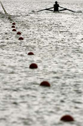 Competitors are silhouetted as they warm up before a heat at the World Rowing Championships in Eton, southern England, August 21, 2006. 