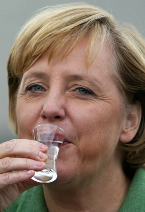 German Chancellor Angela Merkel toasts during the laying of the foundation stone in Grevenbroich, near the western city of Duesseldorf August 23, 2006.