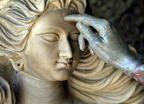 An artisan gives the finishing touches to the face of Hindu deity Durga at a workshop in the northeastern Indian city of Siliguri August 28, 2006. 