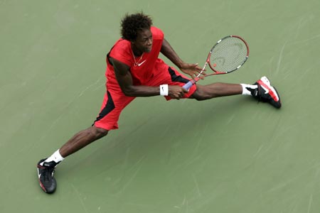 France's Gael Monfils plays a shot to Michael Russell of the United States during their match at the U.S. Open tennis tournament in New York, August 30, 2006.
