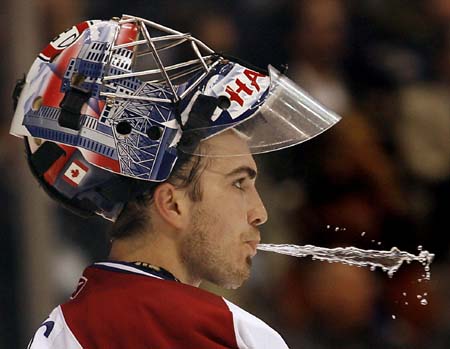 Montreal Canadiens goalie Yann Danis spits out water after allowing Toronto's third goal of the game during the second period of their pre-season NHL hockey game against the Maple Leafs in Toronto.