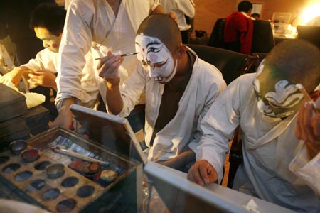 Chinese artists apply make-up before performing in an English version of the traditional Chinese opera Monkey King at a theatre in Shanghai December 8, 2006. Among the performers is Ghaffar Pourazar of Britain (not in photo), the first foreigner to complete the rigorous training at the Beijing Opera School and the National Academy. He is performing with Chinese artists from the International Centre for Beijing Opera, and other troupes, at their first show in Shanghai.