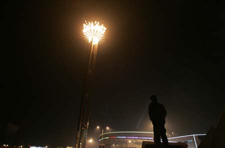 A visitor looks at the torch of the Sixth Asian Winter Games after the opening ceremony in Changchun, northeastern China's Jilin Province, January 28, 2007.