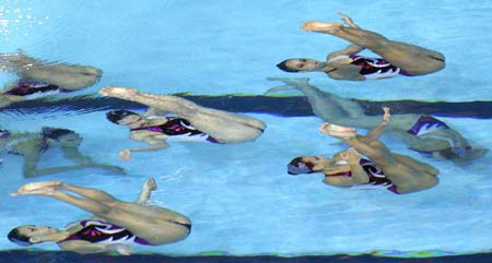 Members of the French team perform in the synchronised swimming free combination routine preliminary round at the World Aquatics Championships at Rod Laver Arena in Melbourne March 17, 2007.