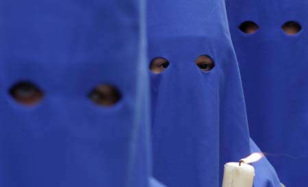 Penitents take part in the procession of 'Prendimiento' brotherhood during Holy Week in Almeria, southeast Spain, April 4, 2007. Hundreds of Easter processions take place in Spain during Holy Week around the clock drawing thousands of visitors. 