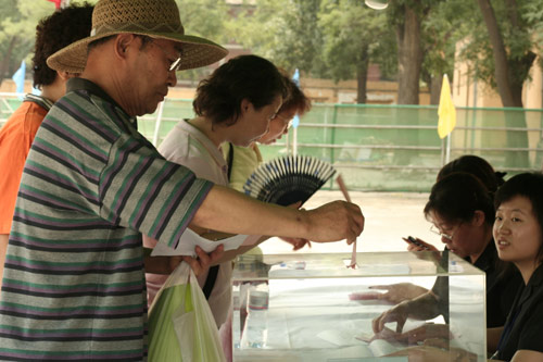 A voter casts his vote on demolishment and reconstruction of old buildings in Juixiaqiao Sub-district in Beijing, June 9, 2007. Local government and the real estate developer jointly organize the vote on Saturday to see if majority residents of over 5000 families accept the new compensation policy after failed attempts to reach an agreement through other ways. Both notary officials and supervisors are invited to monitor the vote that runs from 9 a.m. to 9 p.m. at six ballot booths. [Sun Yuqing/www.szjzcy.com]