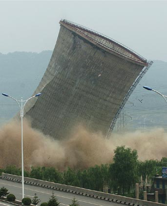 A cooling tower at the HunJiang Power Generation Company is imploded in Baishan,Northeast China's Jilin Province, July 6, 2007. China pledged to cut greenhouse gas emissions as it unveiled its first climate change action plan in early June. China has closed down small thermal power plants with total power generating capacity of 5.5 million kilowatts by now, completing 55 percent of the country's goal for this year, Xinhua reported.