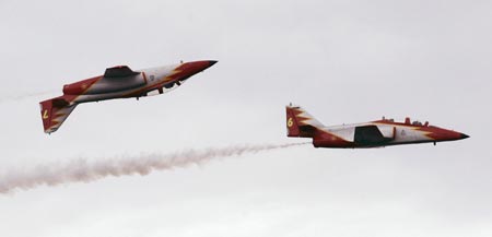 Members of the Spanish Air Force acrobatic group 'Patrulla Aguila' fly over Samil beach in Vigo, northern Spain, during an aerial exhibition July 22, 2007. 