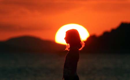 Girl walks in sunset 