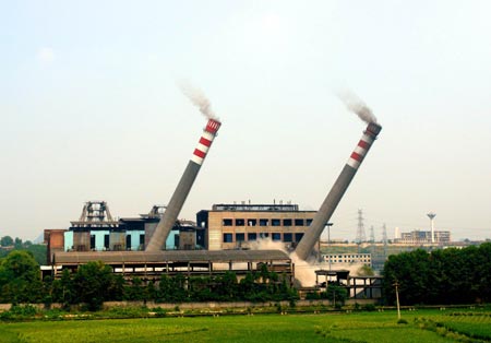Two chimneys fall as they are imploded in Qingzhen, Southwest China's Guizhou Province, August 15, 2007. The implodition aims to protect the water quality and environment in a picturesque area. China shut down small thermal power plants with an installed capacity totaling 6.95 million kilowatts in the first half of the year, completing about 70 percent of the pre-set goal in this regard in 2007, Xinhua News Agency reported. [Xinhua]