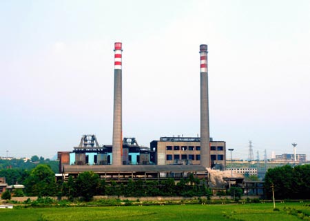 Two chimneys fall as they are imploded in Qingzhen, Southwest China's Guizhou Province, August 15, 2007. The implodition aims to protect the water quality and environment in a picturesque area. China shut down small thermal power plants with an installed capacity totaling 6.95 million kilowatts in the first half of the year, completing about 70 percent of the pre-set goal in this regard in 2007, Xinhua News Agency reported. [Xinhua]