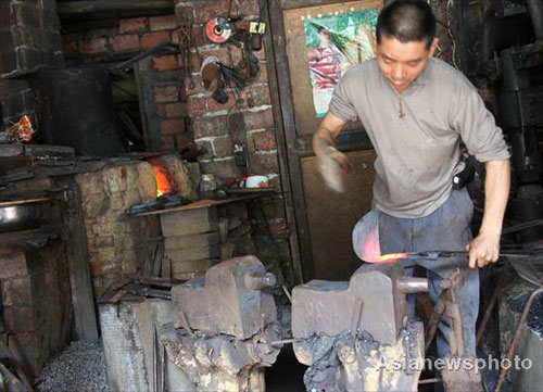 Husband-wife team work together as blacksmiths