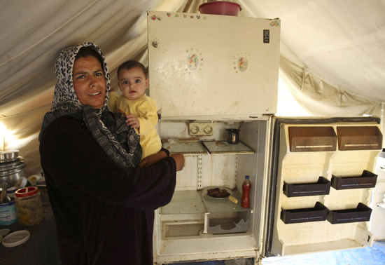Palestinian woman in damaged house