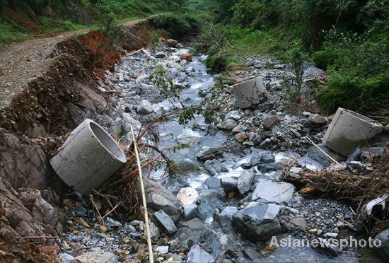 Villagers rebuild sole road after flood