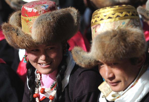 Young Tibetans watch performance to celebrate the upcoming Serfs Emancipation Day in Zhanang county of Southwest China's Tibet autonomous region, March 26, 2011. Tibetans celebrate upcoming Serfs Emancipation Day