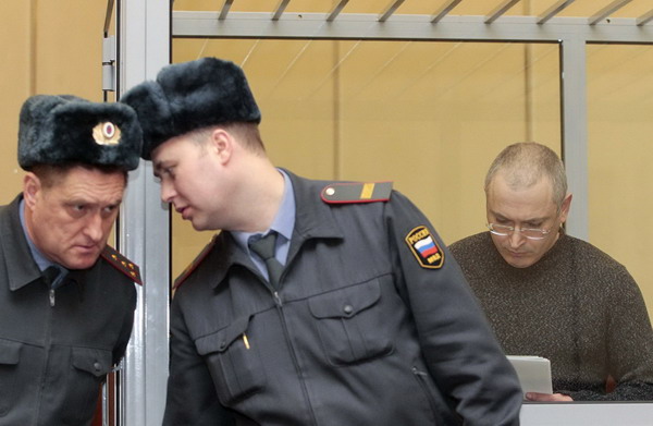 Jailed former oil tycoon stands trial