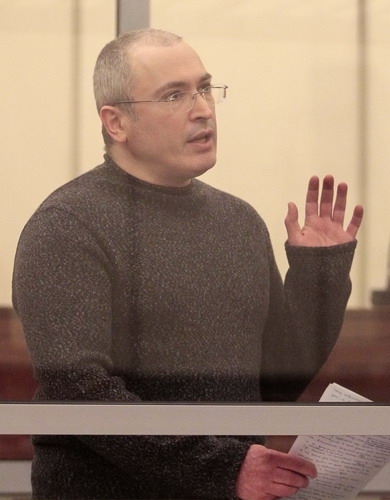 Jailed former oil tycoon stands trial