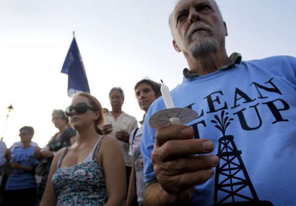 John Koeferl of New Orleans (R) joins members of the Sierra Club, a grassroots environmental organization, during a ceremony to mark the one-year anniversary of the Deepwater Horizon tragedy, in New Orleans, Louisiana April 20, 2011. One-year anniversary of BP oil spill